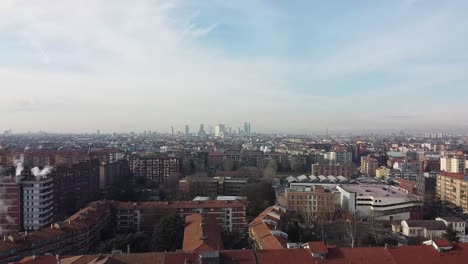 smoking chimney and skyline of milano city, aerial drone view