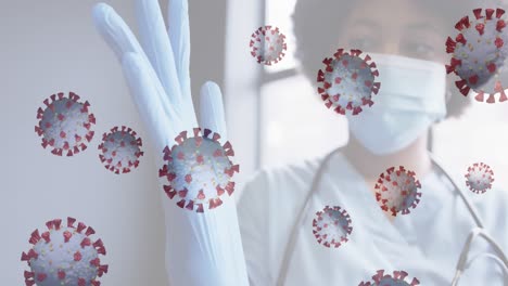 animación de celdas de covid 19 con una doctora que usa una máscara y se pone guantes