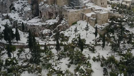 Aerial-view-over-the-snowy-Acropolis-hill,-in-Athens,-Greece---Climate-change-causing-rare-phenomenona-all-around-the-word