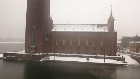 Downward-reverse-drone-shot-showing-side-view-of-City-Hall-Landmark-in-the-capital-city-of-Sweden