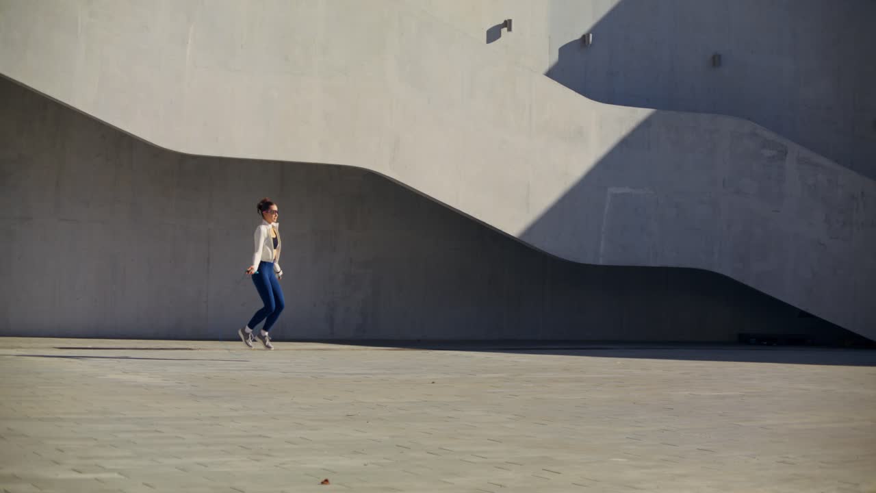 Woman Exercising with Jump Rope Outdoors