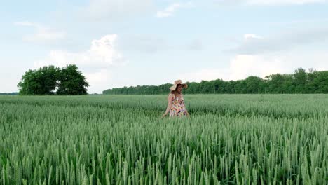 pregnant girl walking in a wheat field