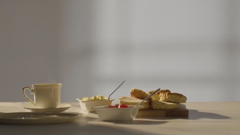 Studioaufnahme-Eines-Traditionellen-Britischen-Nachmittagstees-Mit-Scones,-Sahne-Und-Marmelade-3