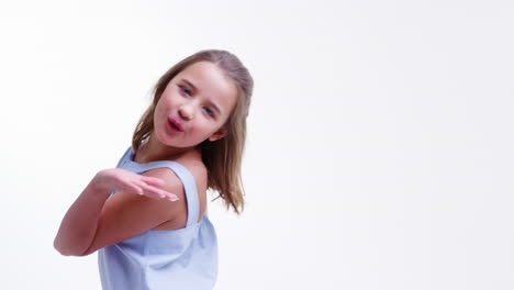 Girl-Walks-Into-Shot-And-Blows-Kiss-Against-White-Background