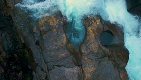 foamy water crashing over mossy rocks in fervenza da noveira nature preserve in a coruña, spain