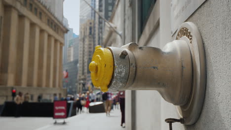 fire hydrant in the wall of a building on wall street in new york