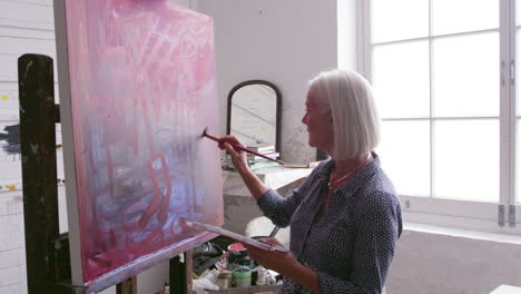 Female-Artist-Working-On-Painting-In-Studio-Shot-On-R3D