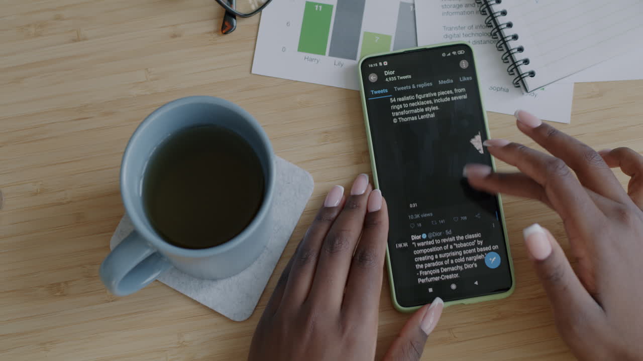 Woman using smartphone to view Dior social media advertisement