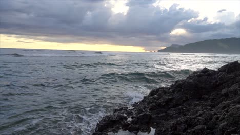 SLOW-MOTION-Waves-Crashing-On-Rocky-Beach-With-Sunset