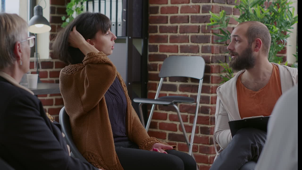 Close up of nervous woman with alcohol addiction having mental breakdown at aa meeting