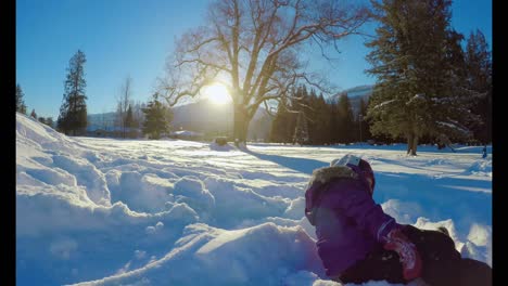 Kid-playing-in-the-snow-during-winter-4k