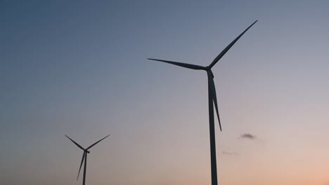 wind turbines silhouette against the blue-sky during sunset, clean alternative energy in thailand and mainland southeast asia