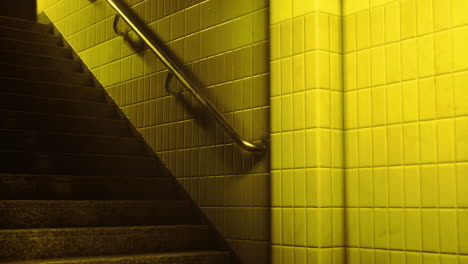 stairs illuminated by warm yellow light in a public building setting