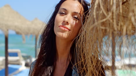 Pretty-Lady-Leaning-her-Head-on-Beach-Umbrella