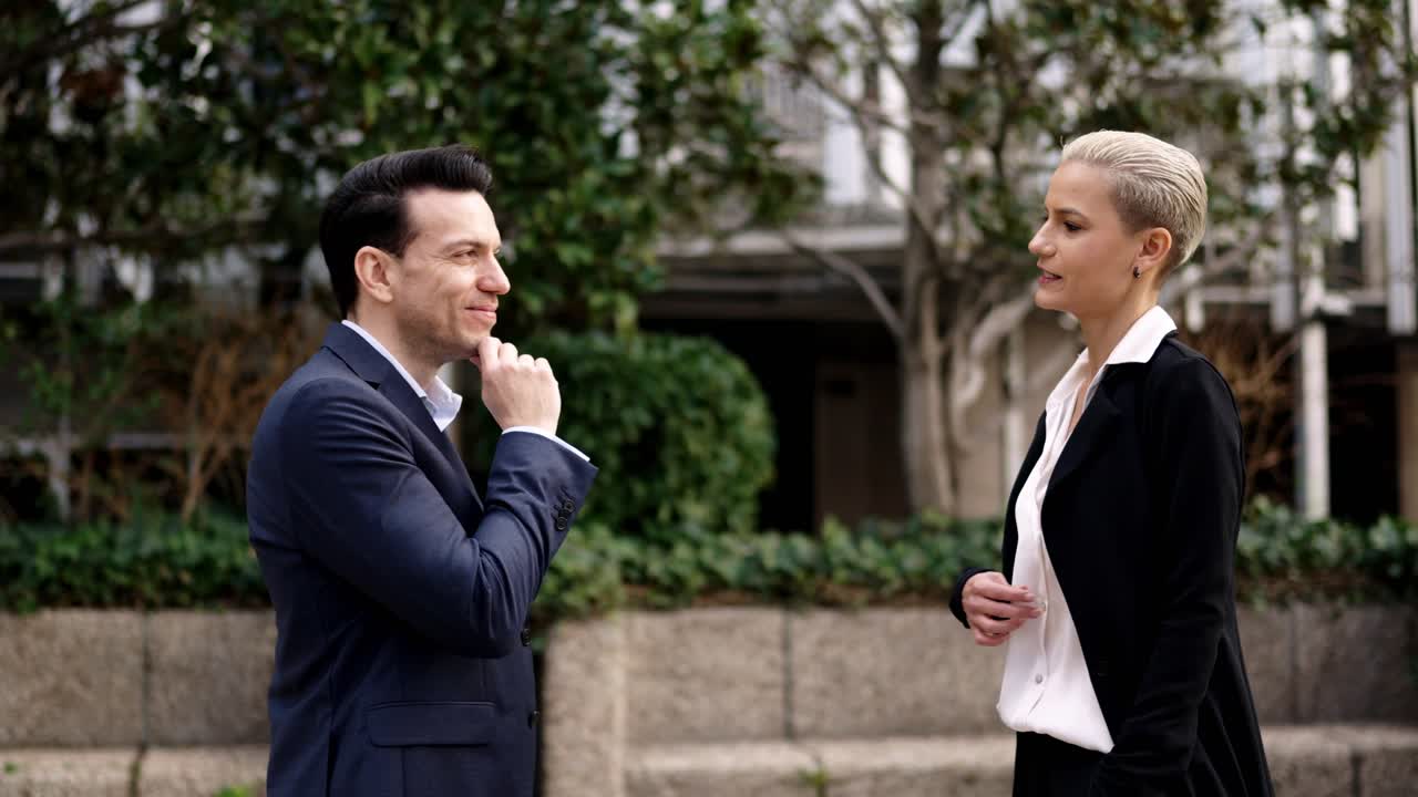 Two business people having a conversation outdoors