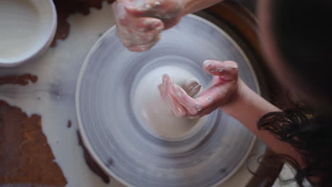 woman working on pottery wheel