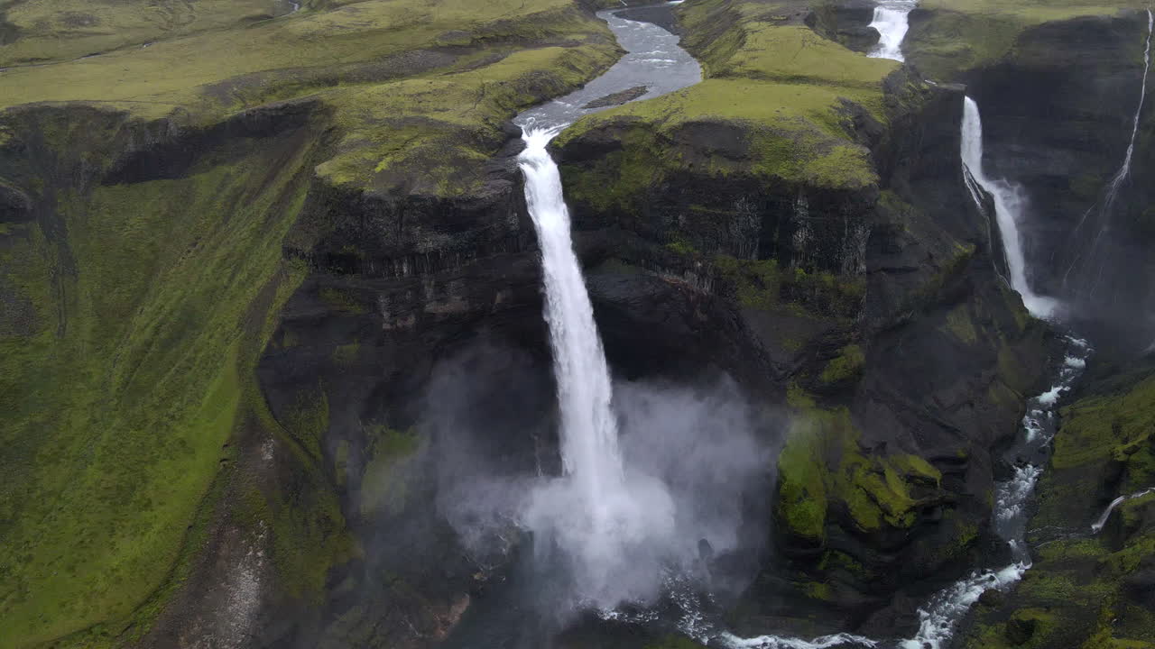 toma panorámica circular aérea de la increíble cascada de haifoss en el desfiladero de la montaña de fossárdalur, en islandia
