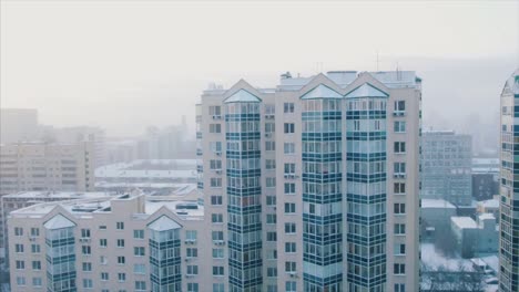 snowy cityscape with high-rise buildings