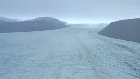 Dolly-back-aerial-shot-over-huge-glacier