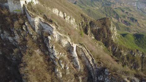 aerial rotates around ridge top wild segment of great wall of china