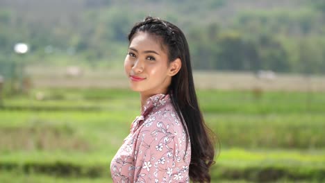 woman in a floral dress at a rice paddy