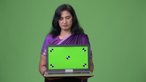 mature beautiful indian woman showing laptop