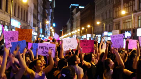 protest with women holding signs at night