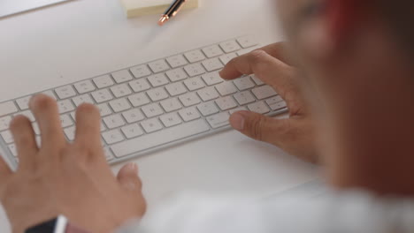 close up hands typing businessman using computer browsing web searching online brainstorming working in office