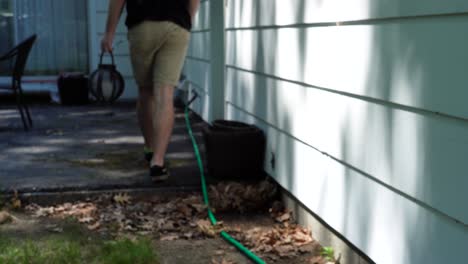 Man-walking-with-a-candle-basket-against-shadows-back-dropping-on-a-house