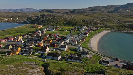 drone flying sideways in front of the pykeija town, summer in finmark, norway