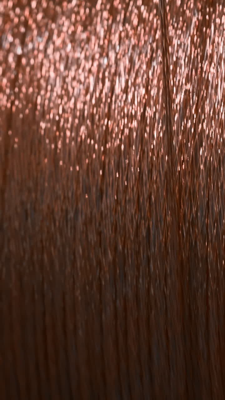 Close-up of a spool of copper-colored embroidery thread