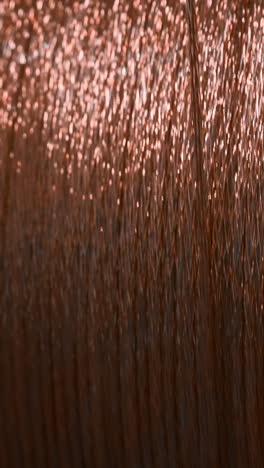 close-up of a spool of copper-colored embroidery thread