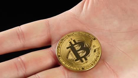 golden bitcoin in hand