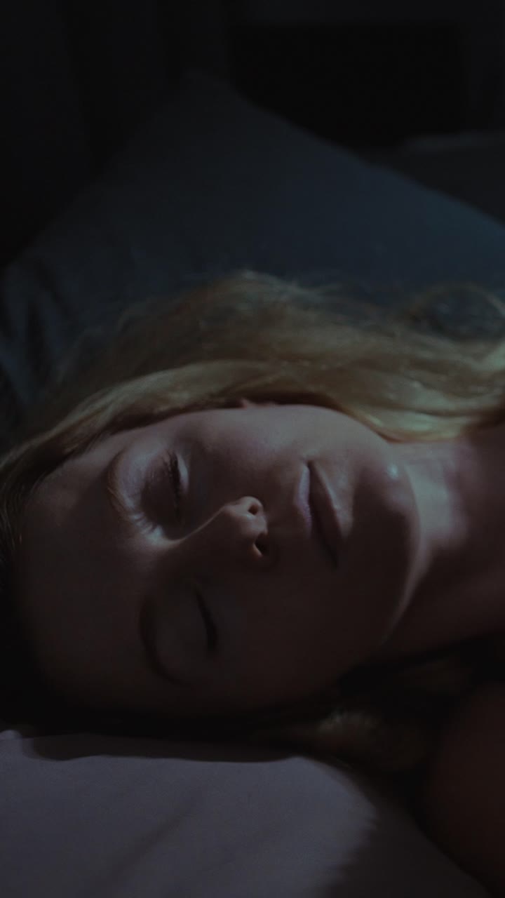 mujer durmiendo en la cama por la noche