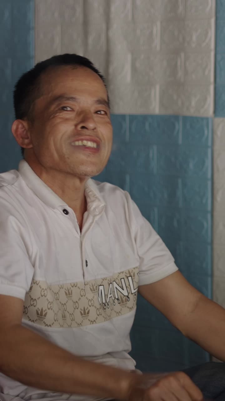 Man smoking a bamboo pipe indoors