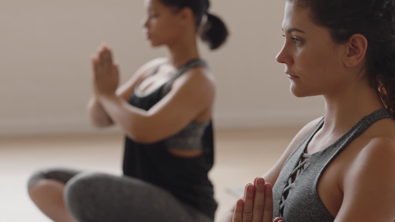 healthy yoga woman practicing prayer pose young caucasian female enjoying fitness lifestyle exercising in studio with group of multiracial women