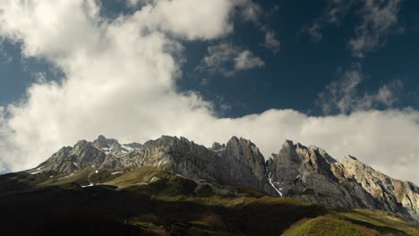 timelapse of fast-moving clouds drifting above the majestic picos de europa mountains in northern spain. dramatic skies meet rugged peaks in a breathtaking natural scene.