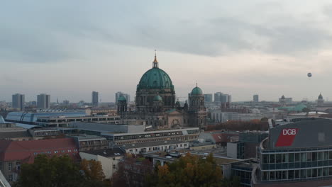Forwards-flying-over-various-buildings-near-historic-valuable-landmark-Berlin-Cathedral.-Evangelical-church-with-large-dome.-Berlin,-Germany.