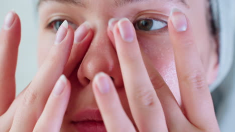 close-up of young woman using hands to massage skincare on her nose, focusing on improving skin texture and treating specific areas, a gentle beauty routine for flawless skin