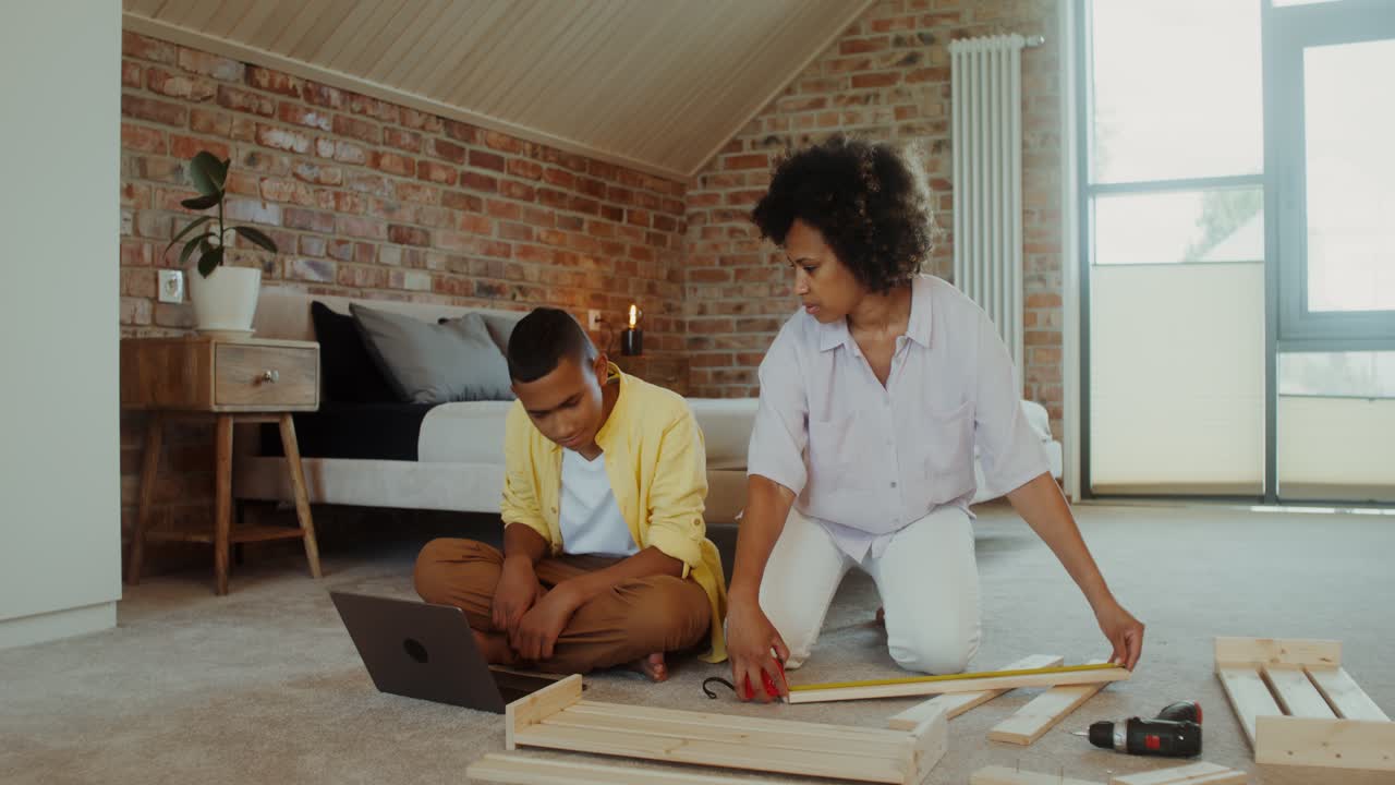 Mother and son building furniture together