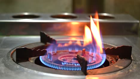 burn burner. gas is switching on, apearing blue flame gas stove video 4k