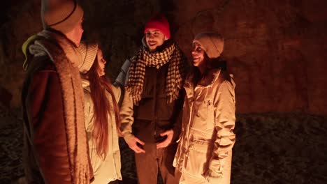 friends by a campfire in a cave