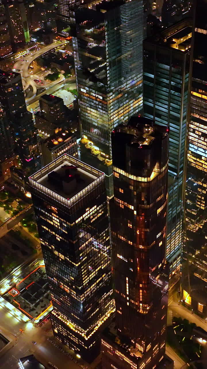 Dazzling panorama of marvelous New York at night. Drone footage over the vibrant city full of light. Vertical video