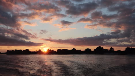 a boat cruise along the namibia side of the zambezi river in summer in the caprivi strip-zambezi region at sunset