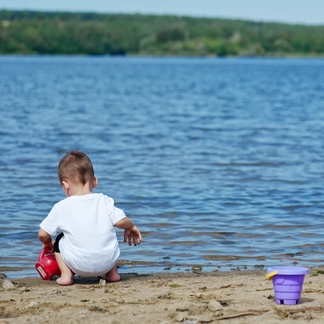 River beach small kid having fun. Cute baby boy playing on water