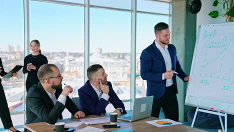 business meeting in modern office center. group of successful entrepreneurs in elegant costumes work together. business concept.