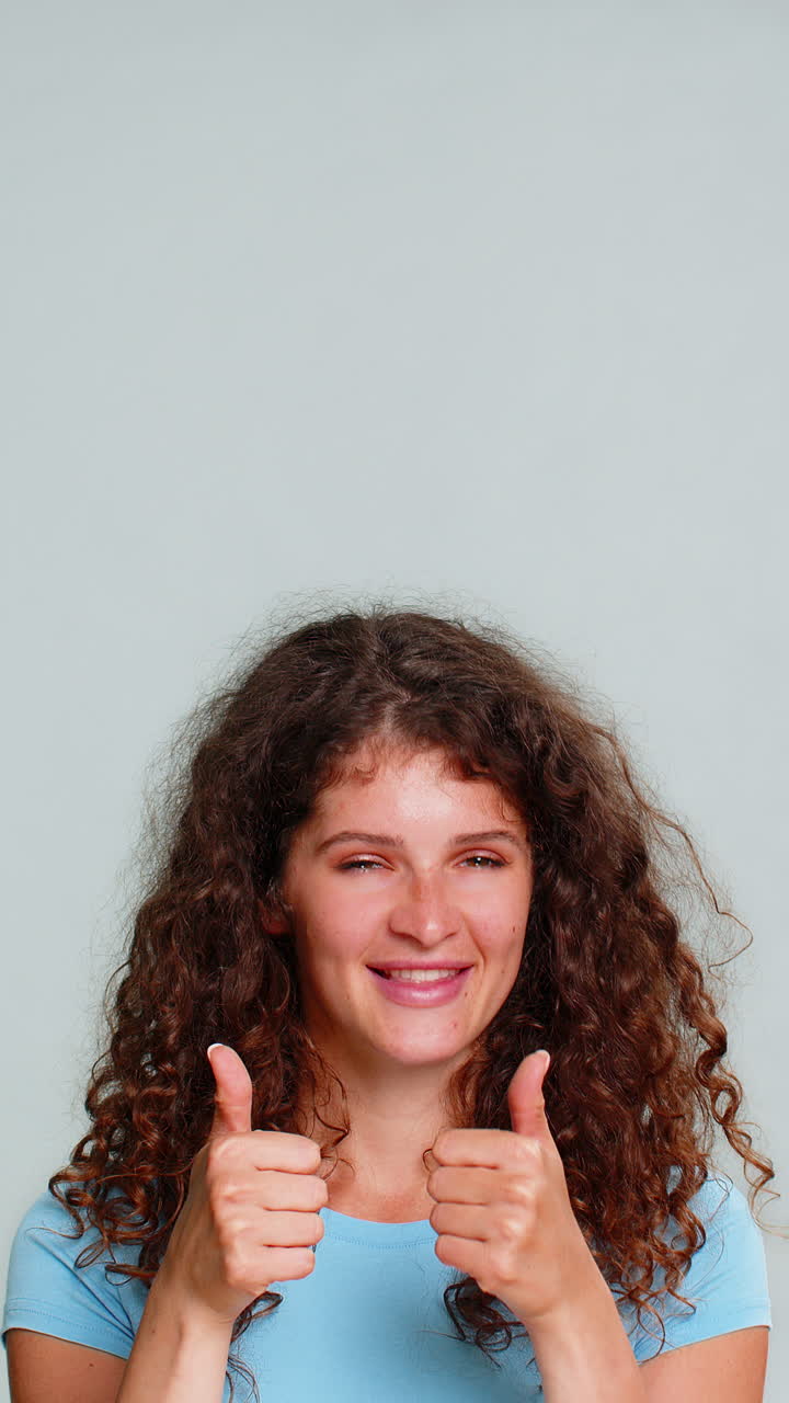 Woman smiling pointing upward presenting advertising promo logo product copy space cheerful gesture