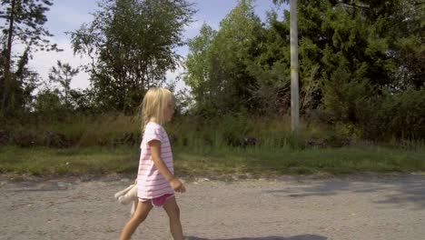 Three-year-old-summer-girl-strolling-with-an-observing-look-to-her-face,-interested