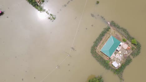 above view of flooded village houses in bangladesh, south asia. aerial drone shot