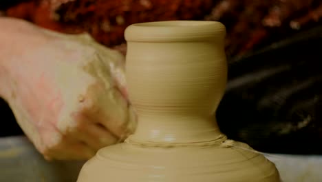 professional male potter working in workshop, studio